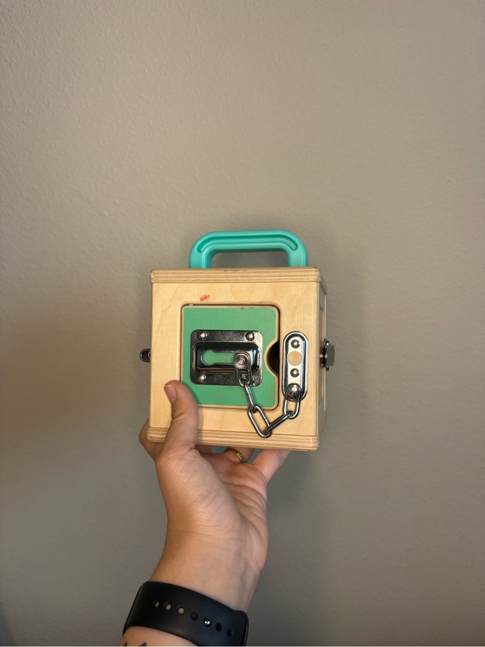 Wooden Busy Box with Teal Handle and Green Panel